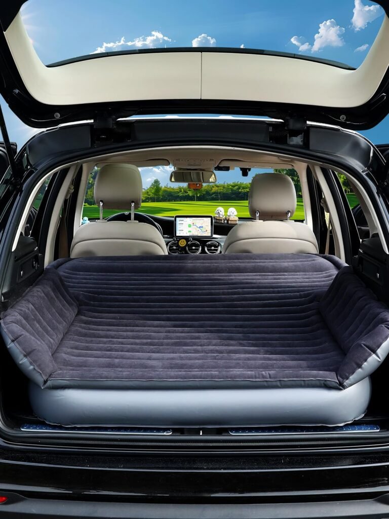 Car interior with an inflatable mattress in the trunk, open to a scenic view