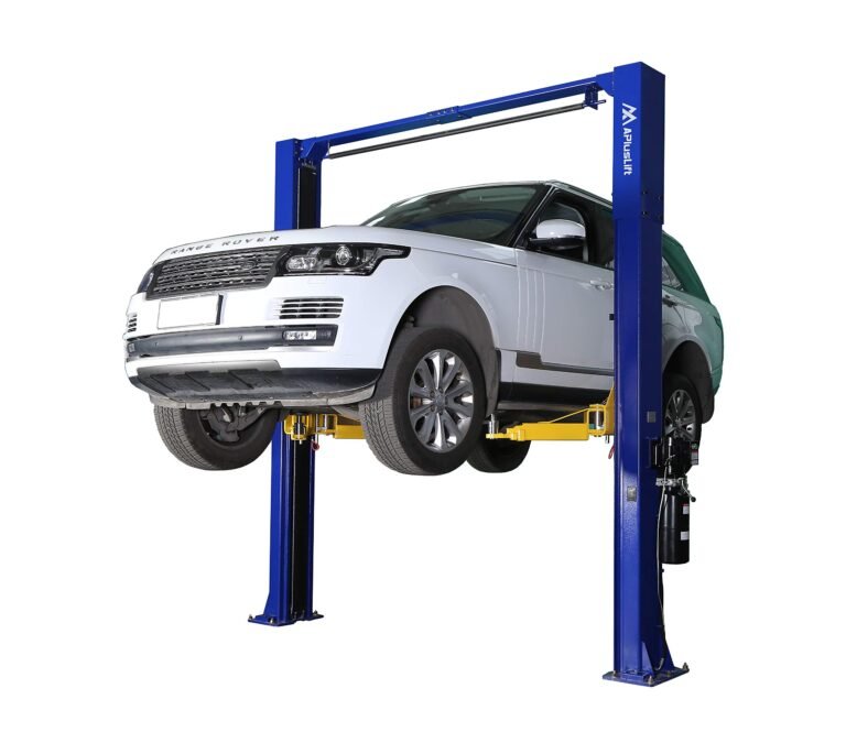 White Range Rover SUV lifted on a blue and yellow car lift