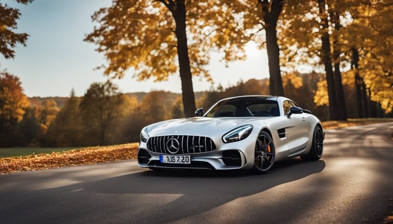 Silver Mercedes-AMG sports car parked on a road in autumn scenery